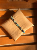 Handmade sky blue daisy seed bead bracelet on deep navy base with white centers