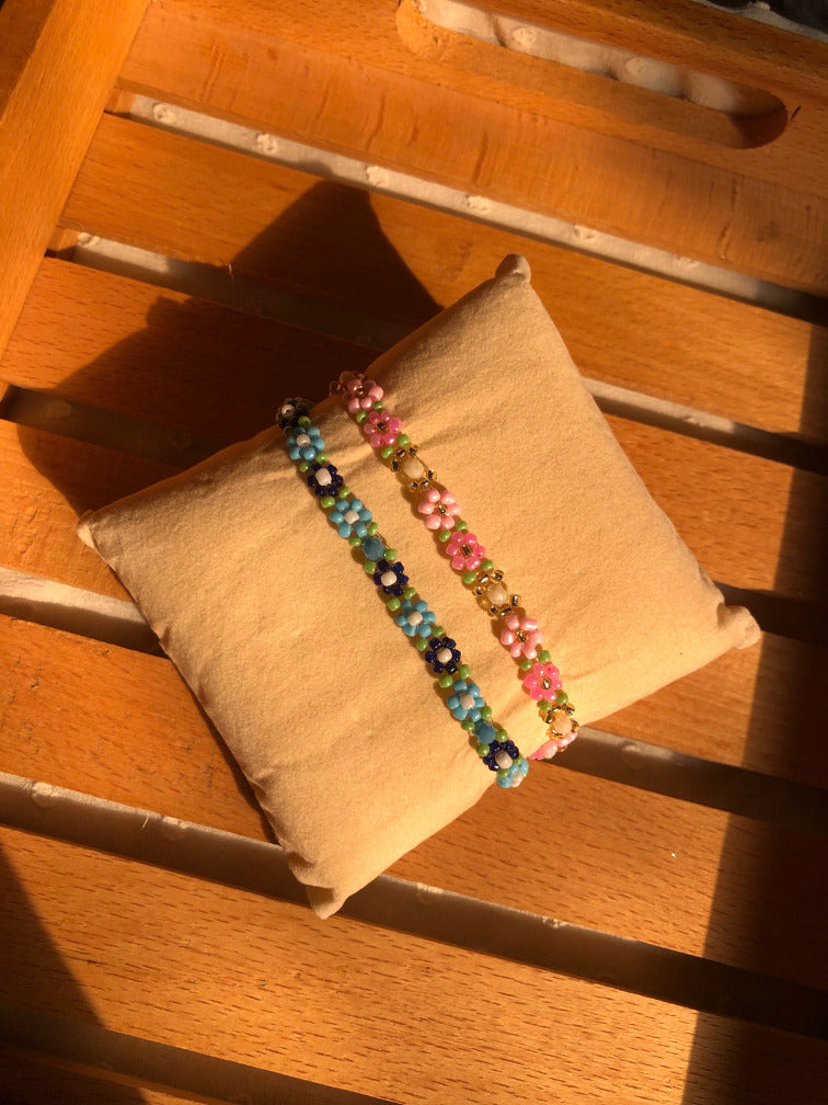 Blue and navy daisy bracelet stacked with pink green daisy bracelet 