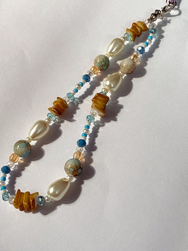 Handmade oval pearl and turquoise beaded phone charm with silver clasp